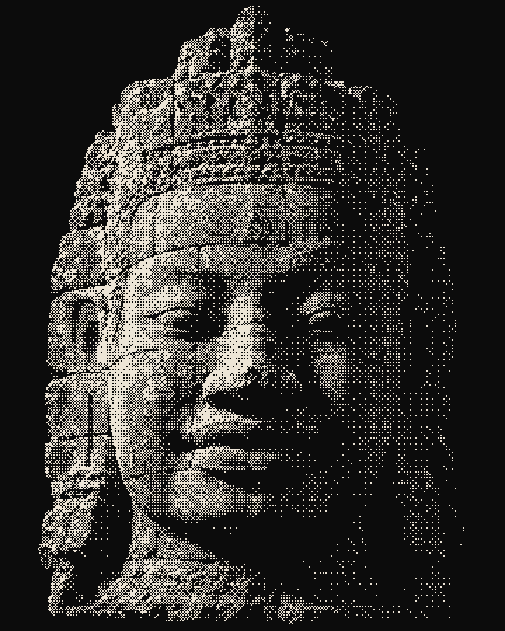 A serene smiling stone face of a Bayon temple tower